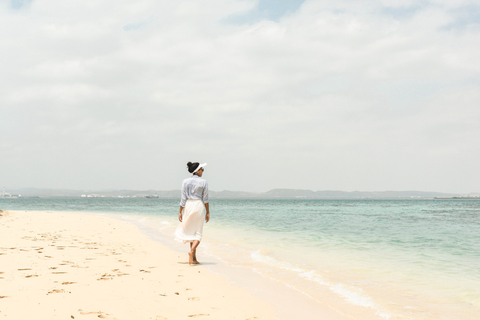 Woman walking on beach in Massawa Eritrea Red Sea