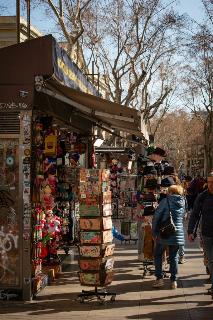 Woman looking at kiosk on La Rambla in Barcelona